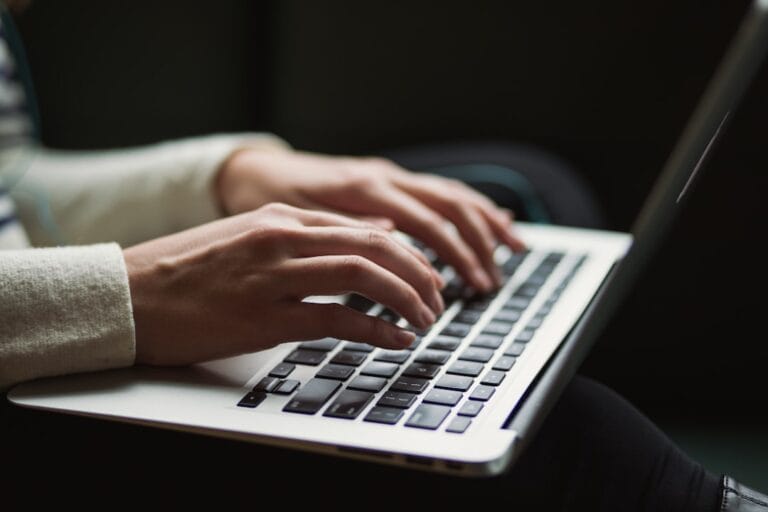 Person using a laptop, representing starting a career change into IT audit with no technical background
